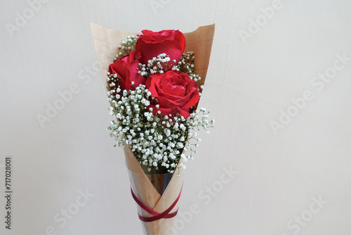 Three red rose mix with baby breath bouquet photo