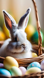 Cute rabbit sitting in a basket with colorful Easter eggs, perfect for spring holiday themes. Easter concept.