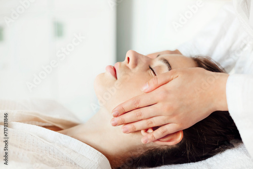 Crop massage therapist massaging face of client © Dasha Petrenko