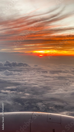 View from Airplane Window in Flight at Sunset