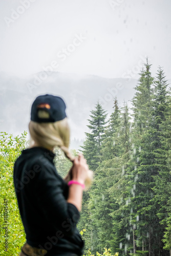 girl looks at the mountains. girl in a cap. Mountains after the rain. Water from the forest evaporates. precipitation in the mountains. rain in the forest. Carpathians. Wet