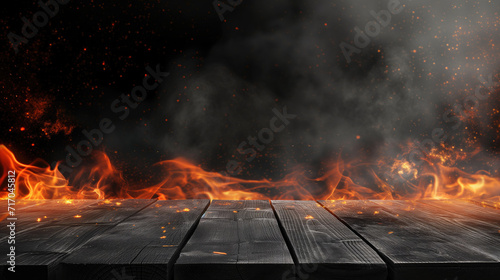 Empty black wooden table with flames and sparks rising above charred wooden planks against a dark smoky backdrop. Empty Space for display your products.