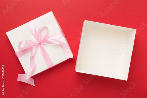White open gift box on color background, top view. Mock up for design