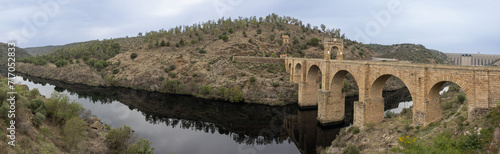 Panoramic photograph of the Alcántara Bridge over the Tagus River. An authentic engineering work carried out by the Roman Empire. Alcantara, Caceres, Spain photo