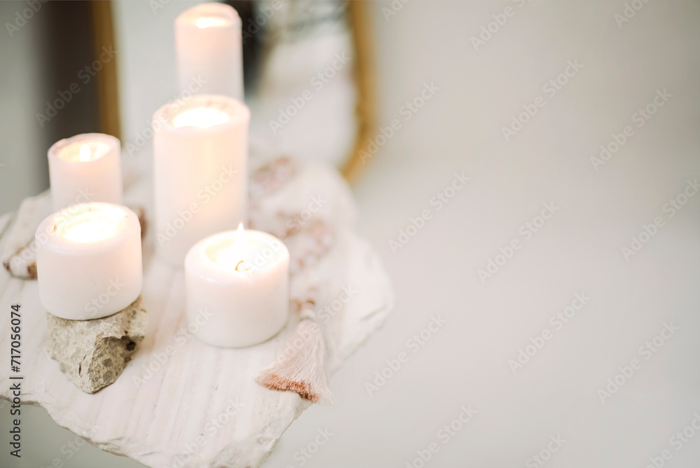 Photo of burning candles of different sizes and praying rosary beads on stand of stone and concrete Photo of burning candles of different sizes and praying rosary beads on stand of stone and concrete