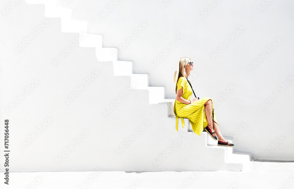 Stylish woman on white stairs in sunlight - obrazy, fototapety, plakaty 