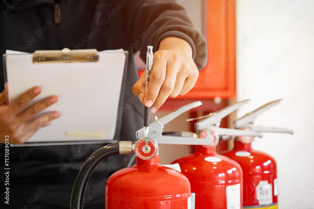 Engineer check fire suppression system,check fire extinguisher tank in the fire control room for safety