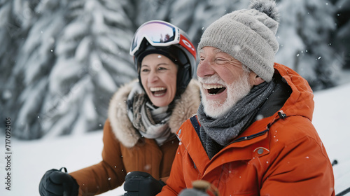 old gray-haired happy man and woman skiing and laughing