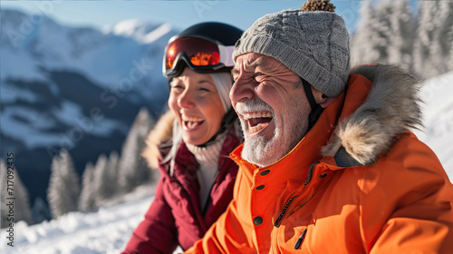 old gray-haired happy man and woman skiing and laughing