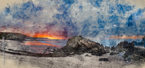 Digital watercolour painting of Beautiful sunrise landscape image of Kennack Sands in Cornwall UK wuth dramatic moody clouds and vibrant sunburst