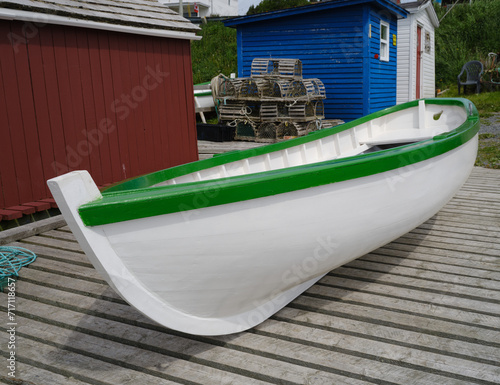 Beautifully painted white and green skiff or rowboat on a working dock in Dildo Newfoundland photo
