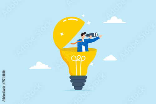 Businessman open lightbulb idea and using binoculars to see business vision