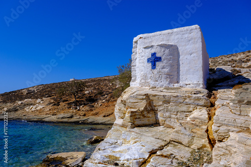 Tiny white church by the sea on Tinos Island, Greece photo