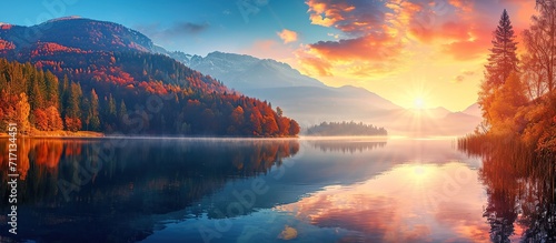 view of the calm lake with the reflection of the colorful sunset #717134451