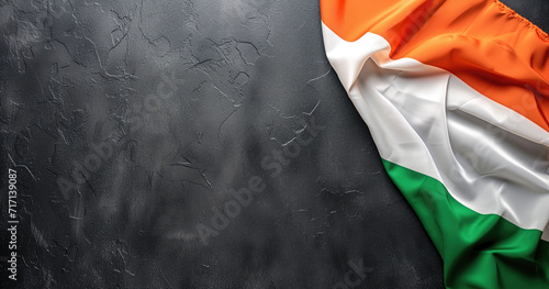 Irish flag draped against a dark textured background photo