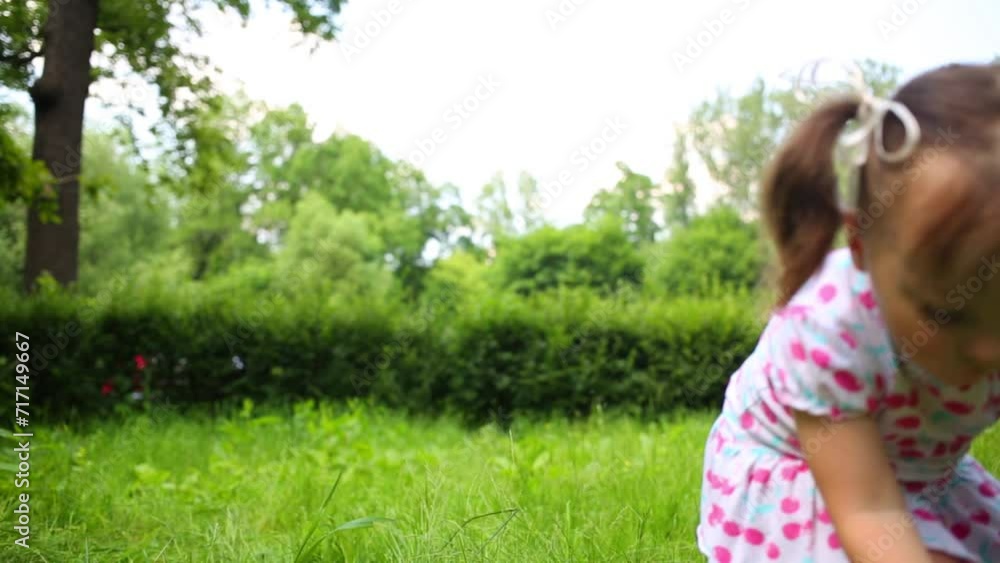 Little cute girl throws paper airplane in summer park Little cute girl throws paper airplane in summer park