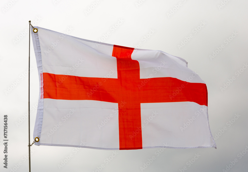 Waving flag of England against a cloudy sky