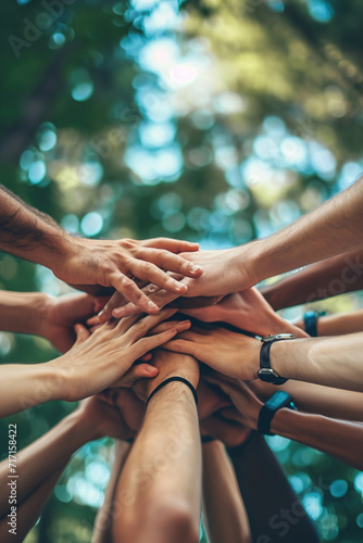 Team-building outings or events, many hands clasped together.