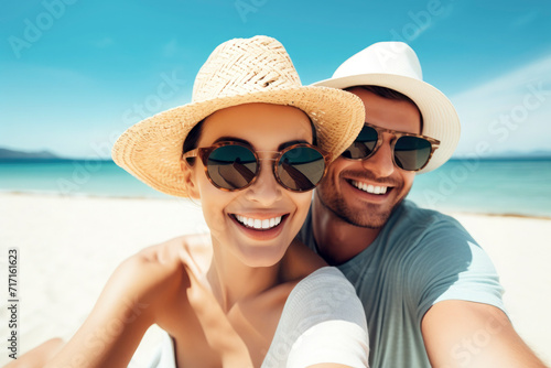 beautiful young couple smiling at the beach, summertime and vacation concept © Eva Corbella