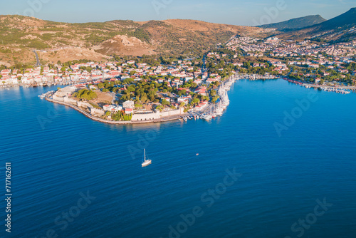 Yacht cruising near Foca resort town, Izmir region Turkiye. Aerial establishing shot © Leonid