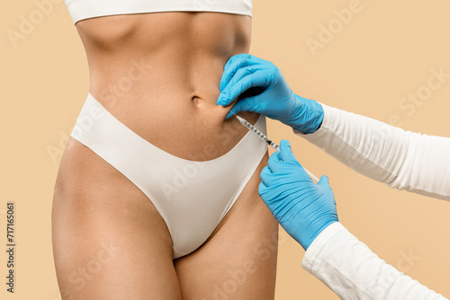 Fat Dissolving Injections. Doctor Making Lipolysis Shot With Syringe To Female Belly © Prostock-studio