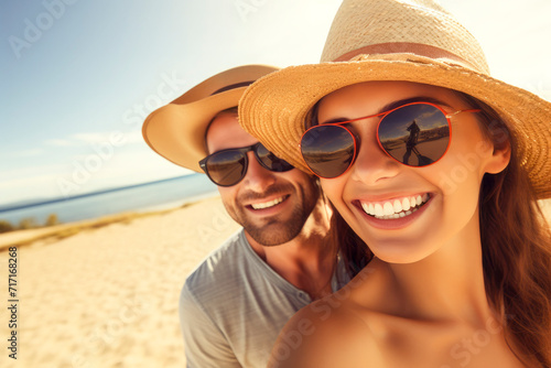 beautiful young couple smiling at the beach, summertime and vacation concept