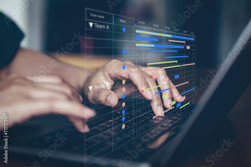 Business Planning and Schedule Plan table on screen with people working on desk. Business people set plan and schedule meeting.