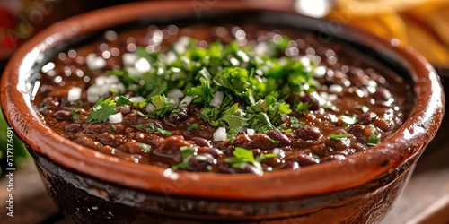 Bean-Lovers' Delight: Enfrijoladas Elegance. Dive into the Corn Tortillas Bathed in Velvety Black Bean Sauce, a Hearty Mexican Comfort Dish. Picture the Bean-Lovers' Delight in a Traditional Mexican photo