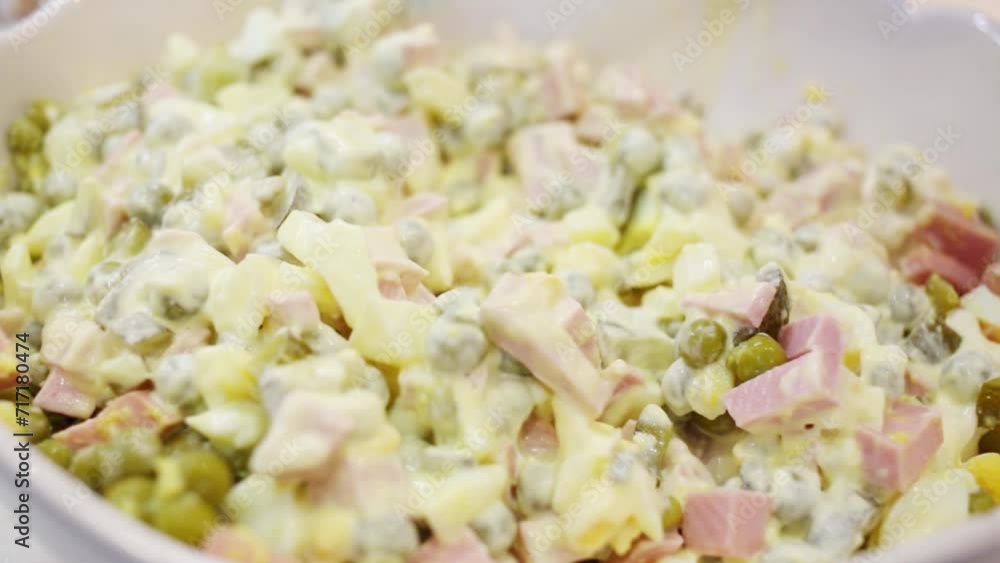 Spoon mixes mayonnaise sauce, green peas, boiled eggs in salad Spoon mixes mayonnaise sauce, green peas, boiled eggs in salad
