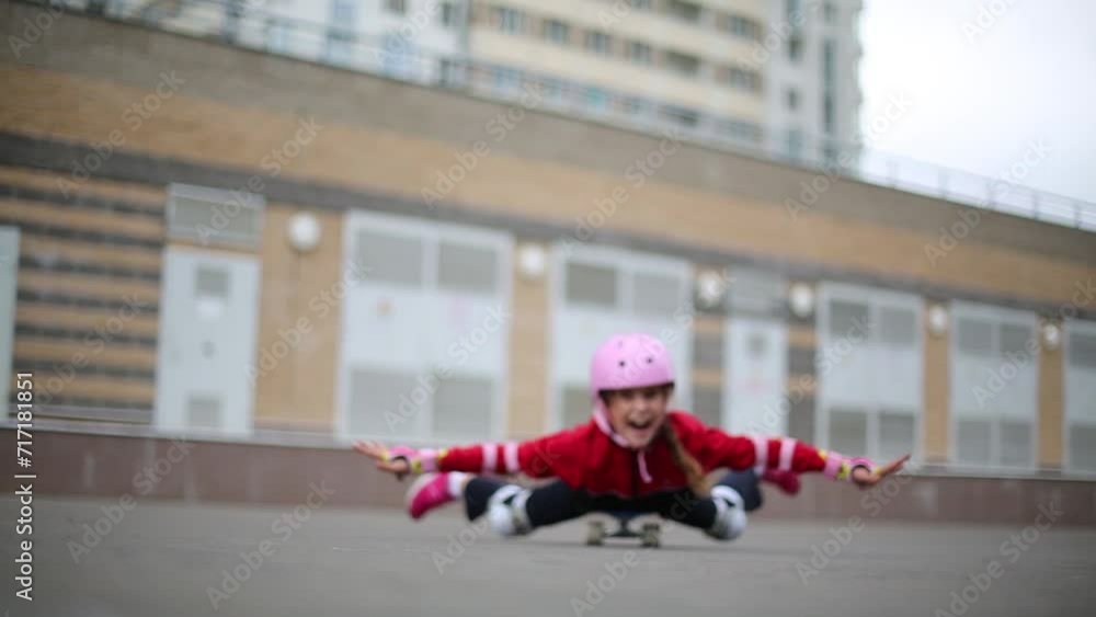 The girl lies on a skateboard and rolls away from the camera The girl lies on a skateboard and rolls away from the camera