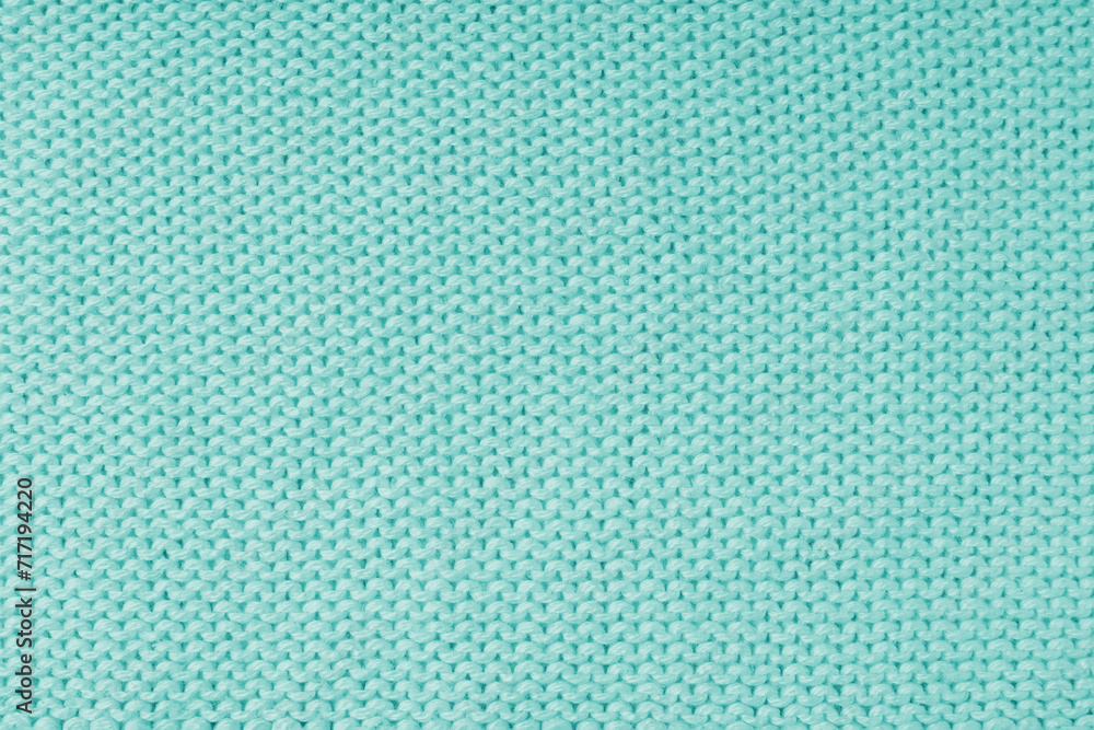 Close up background of knitted wool fabric made of viscose yarn, turquoise color wool knitwear texture. Sweater, pullover knitted jersey background. Fabric abstract backdrop, wallpaper Close up background of knitted wool fabric made of viscose yarn, turquoise color wool knitwear texture. Sweater, pullover knitted jersey background. Fabric abstract backdrop, wallpaper