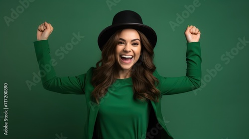 Young beautiful brunette woman wearing green hat on st patricks day celebration excited for success with arms raised and eyes closed celebrating victory smiling. photo