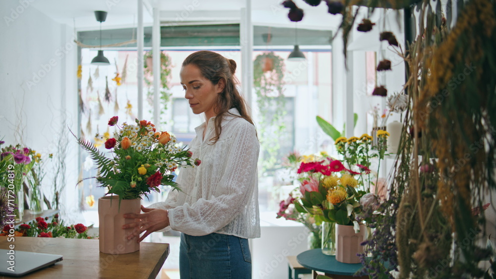 Flower store retailer work make bouquet in beautiful spring plant shop business.