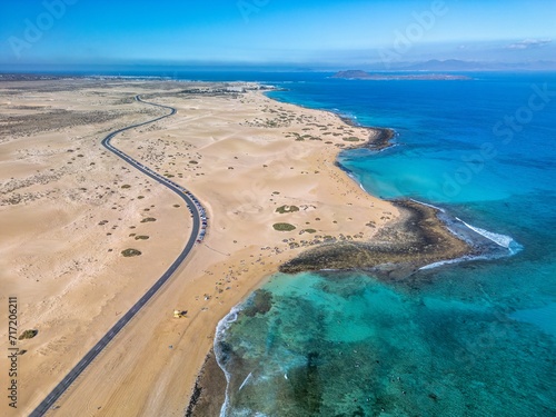 The drone aerial view of Corralejo Natural Park and grand Corralejo beach. Corralejo Natural Park is the best place to go to enjoy the desert beauty of Fuerteventura. photo