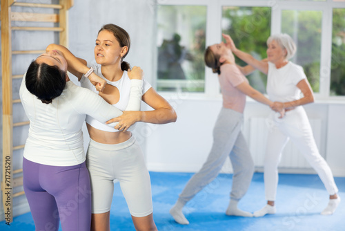 Active women are training captures on the self-defense course in gym © JackF