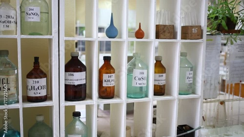 Bottles on shelves with chemical substances and preparations photo