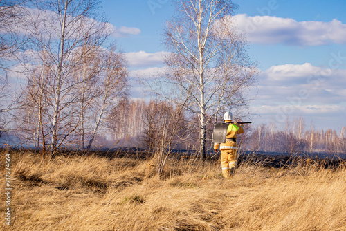 A fireman extinguishes dead wood in the spring.