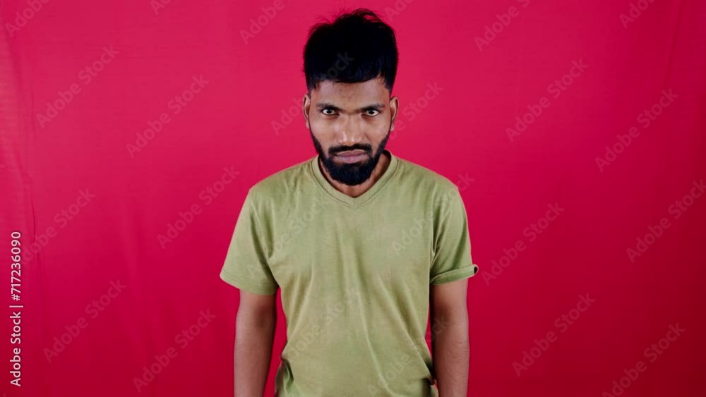 angry young man depressed posing against red background angry young man depressed posing against red background
