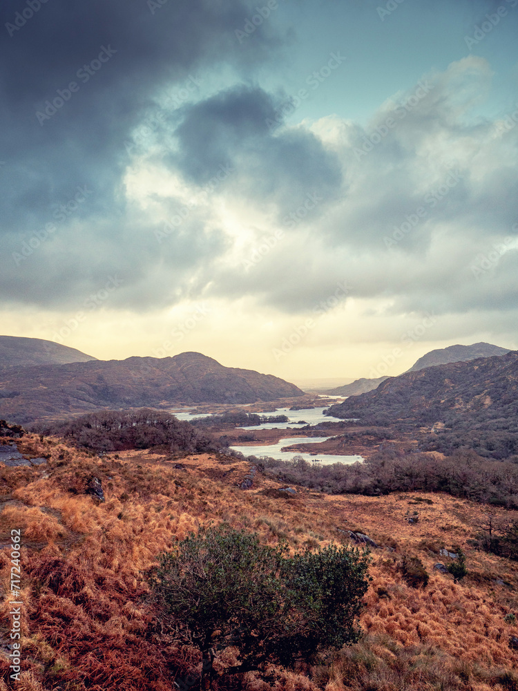 Amazing nature scene with mountains and dark dramatic sky. Ladies view, Killarney, Ireland, ring of Kerry route. Magnificent Irish nature and popular travel and tourist area. Cinematic look.