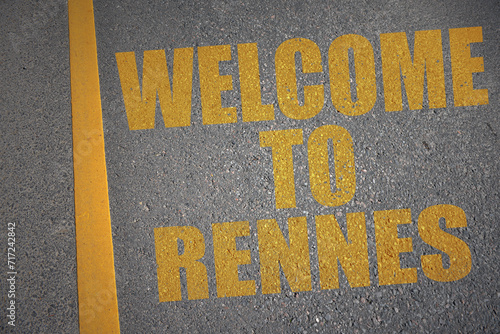 asphalt road with text welcome to Rennes near yellow line. photo
