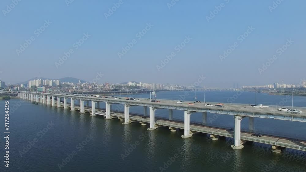 Banpodaegyo bridge with transport traffic and city on shore of river Banpodaegyo bridge with transport traffic and city on shore of river
