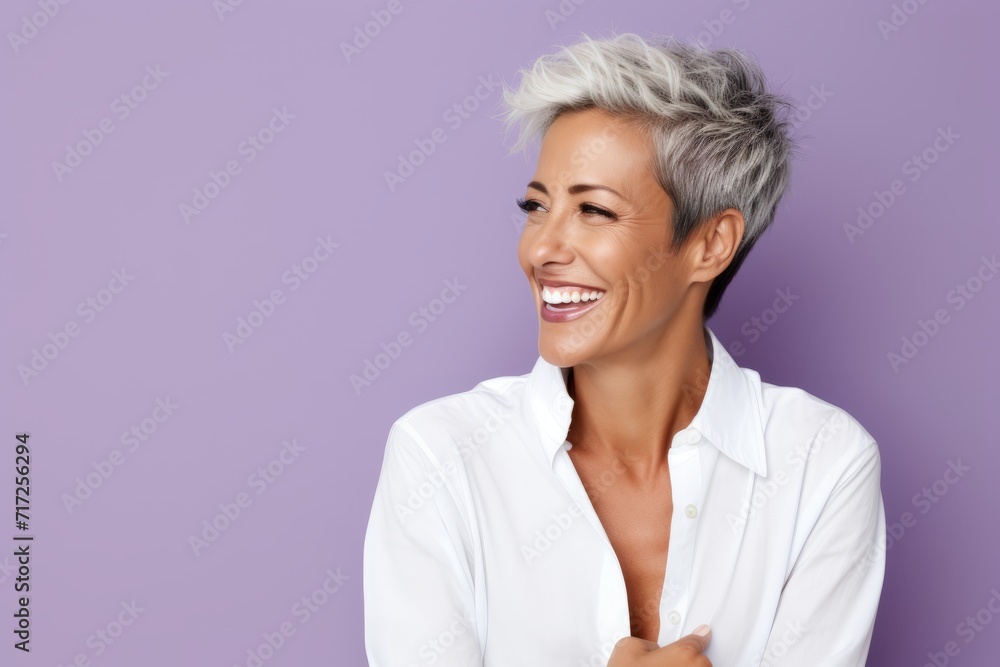 Cheerful mature woman with short grey hair, isolated on violet background Cheerful mature woman with short grey hair, isolated on violet background