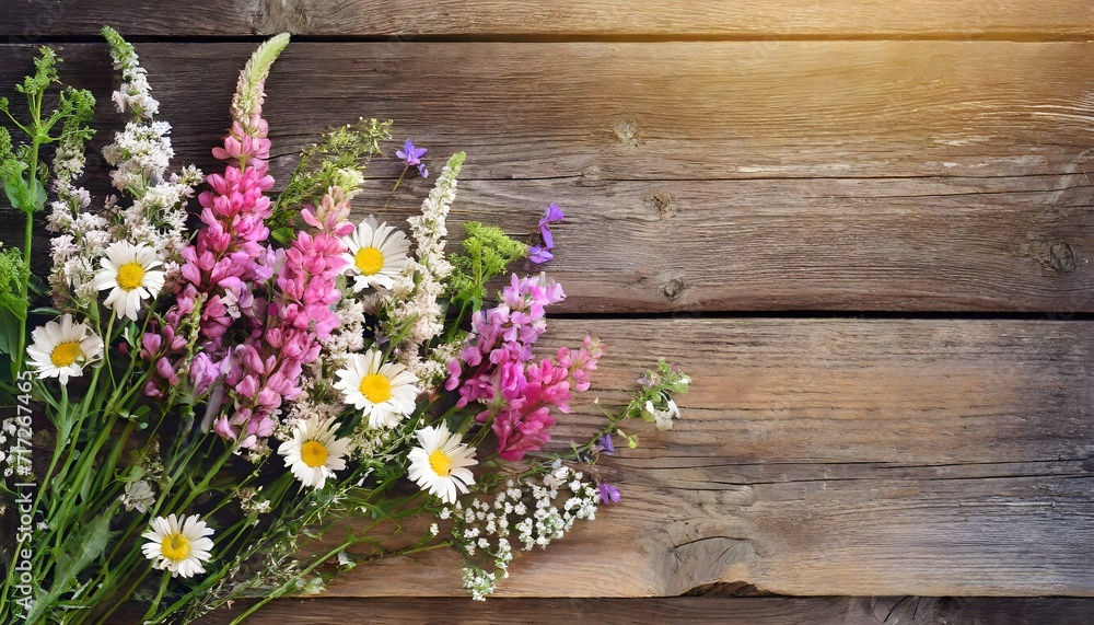 Summer flowers on wooden background with copy space Summer flowers on wooden background with copy space