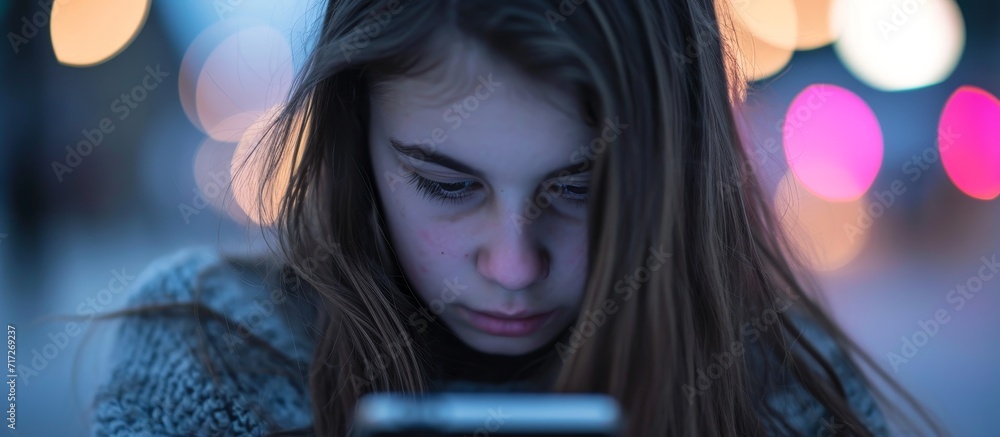 Fototapeta premium Cyberbullying victim: girl using smartphone experiences online harassment.