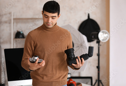 Young male photographer wit...