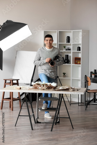Young male photographer wit...