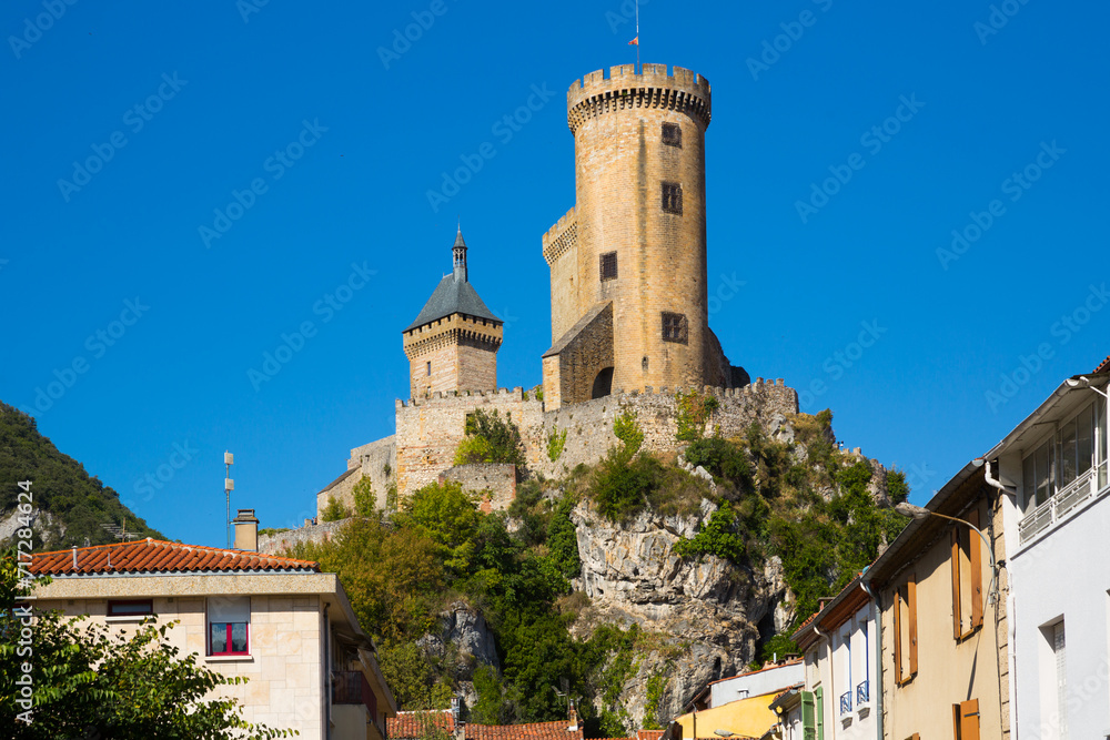 View from city streets on towers of medieval fortress Chateau de Foix, France..