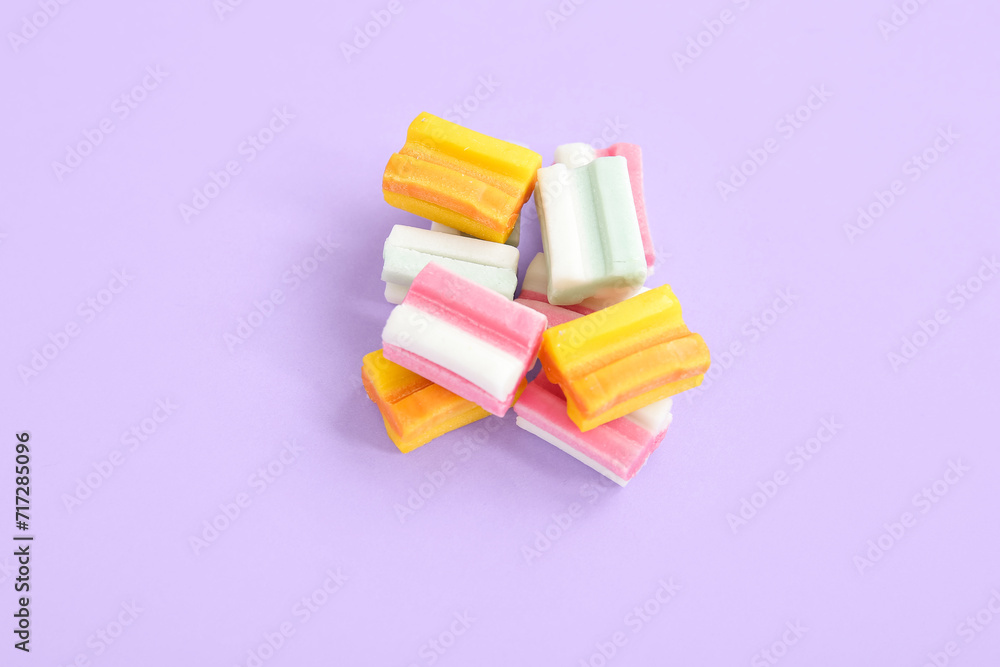 Color chewing gums on lilac background Color chewing gums on lilac background