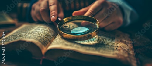 Someone studying Christianity using the Bible, research, and a magnifying glass to understand the concepts of religion, the Holy Spirit, and God's gospel for worship, learning about spiritual photo