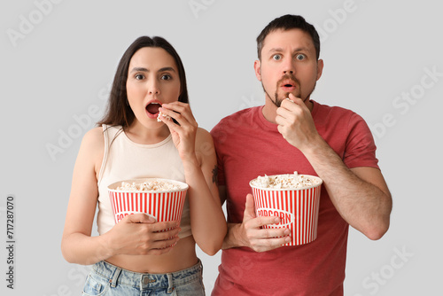 Shocked young couple eating...